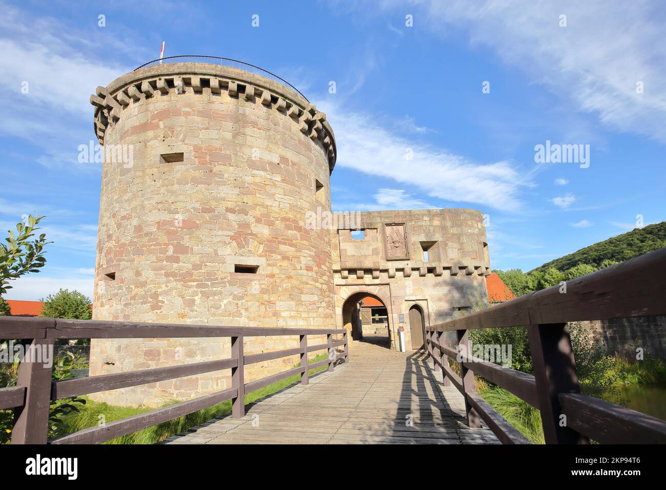 Historic medieval moated castle with bulwark and bridge, archway