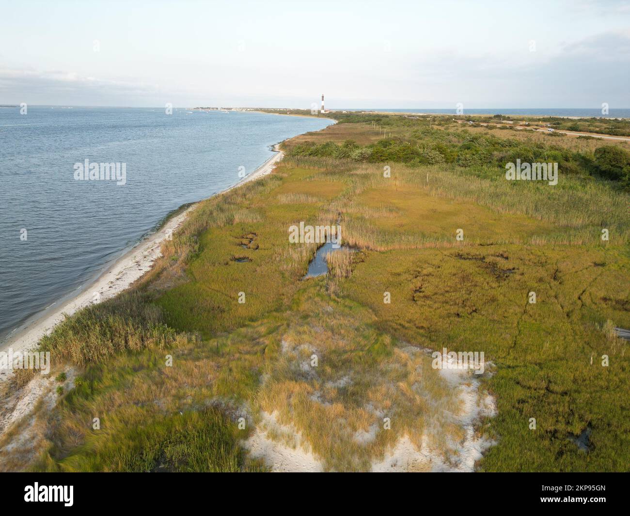 An aerial view of an ocean with a lighthouse in the background Stock ...