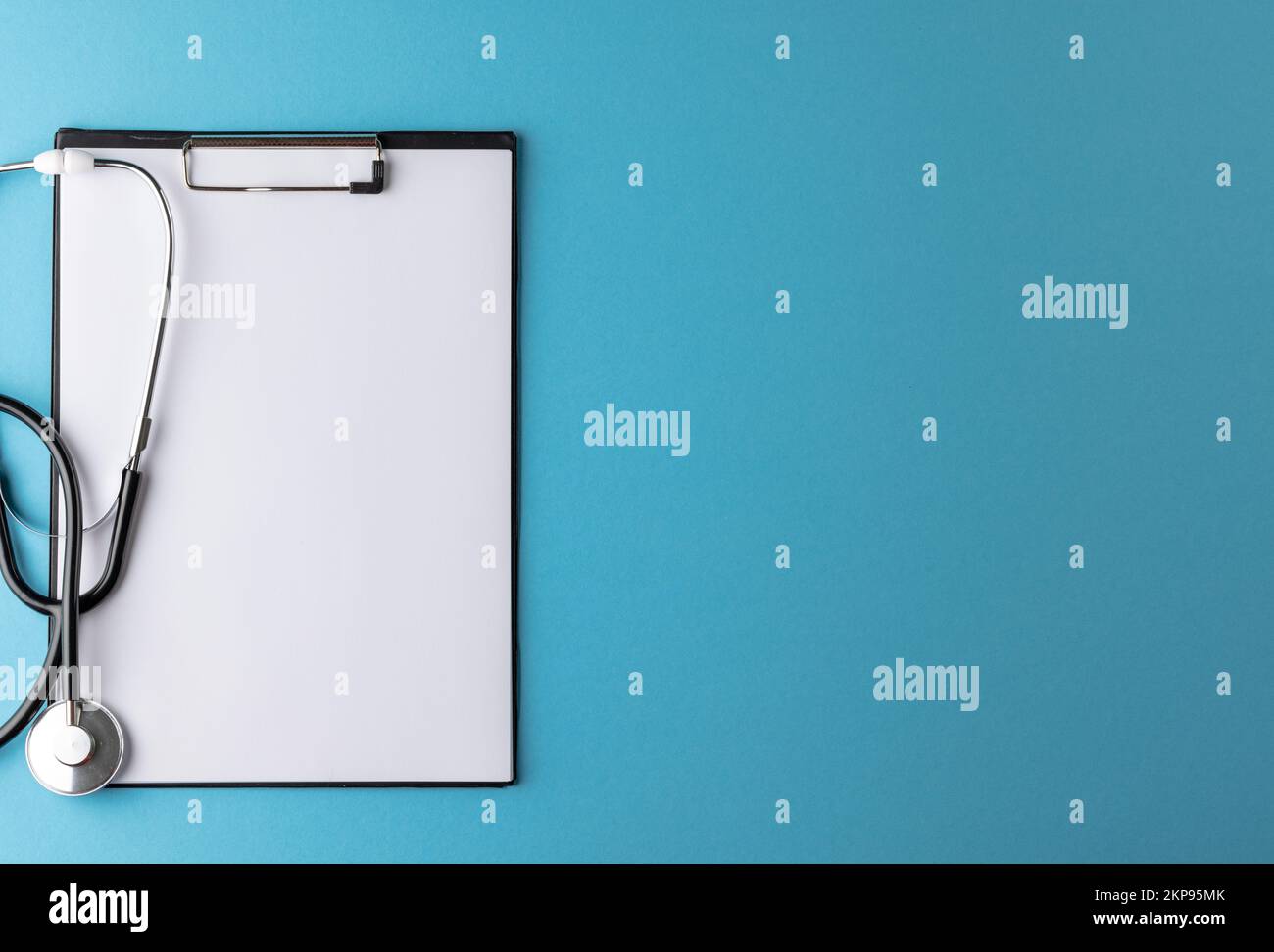 Composition of stethoscope with clipboard on blue background with copy ...