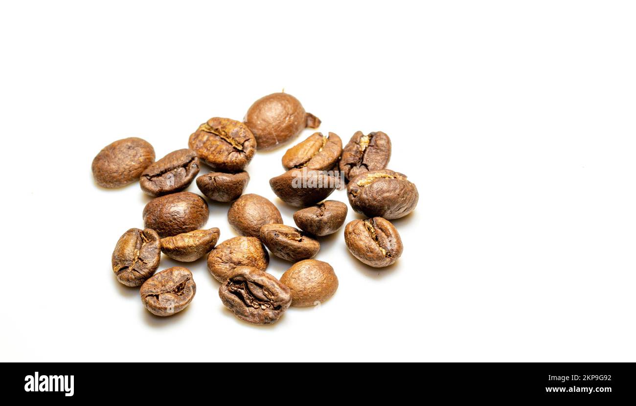 A pile of brown coffee beans on a white table background Stock Photo ...