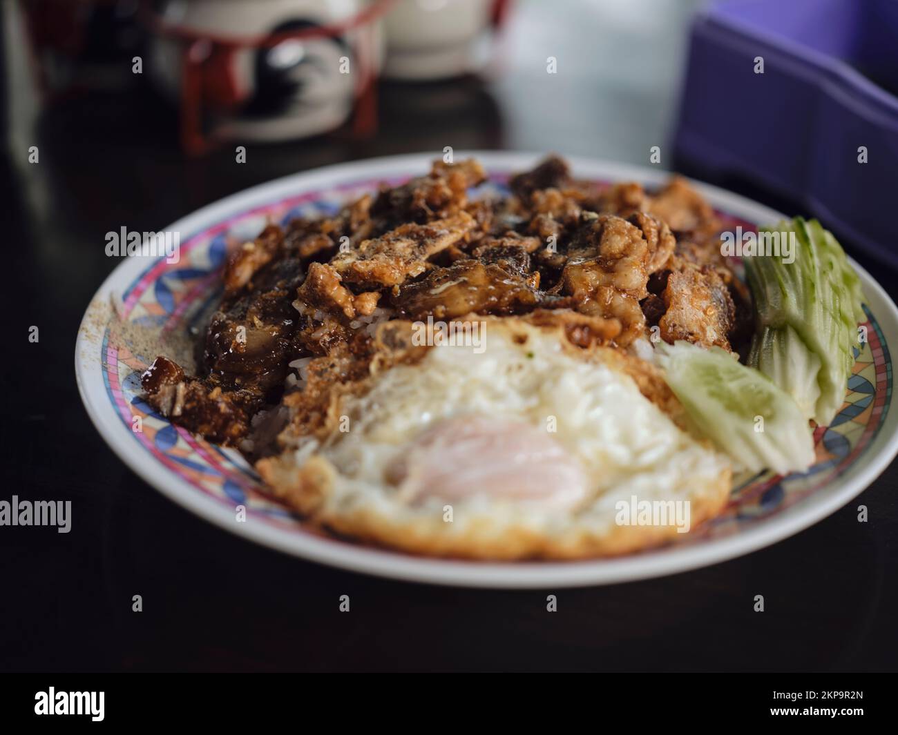 Fried Pork with Garlic, Pepper and fried egg on rice. Stock Photo