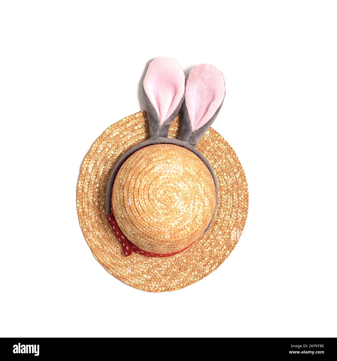 Wicker straw hat with funny push bunny ears on white Stock Photo