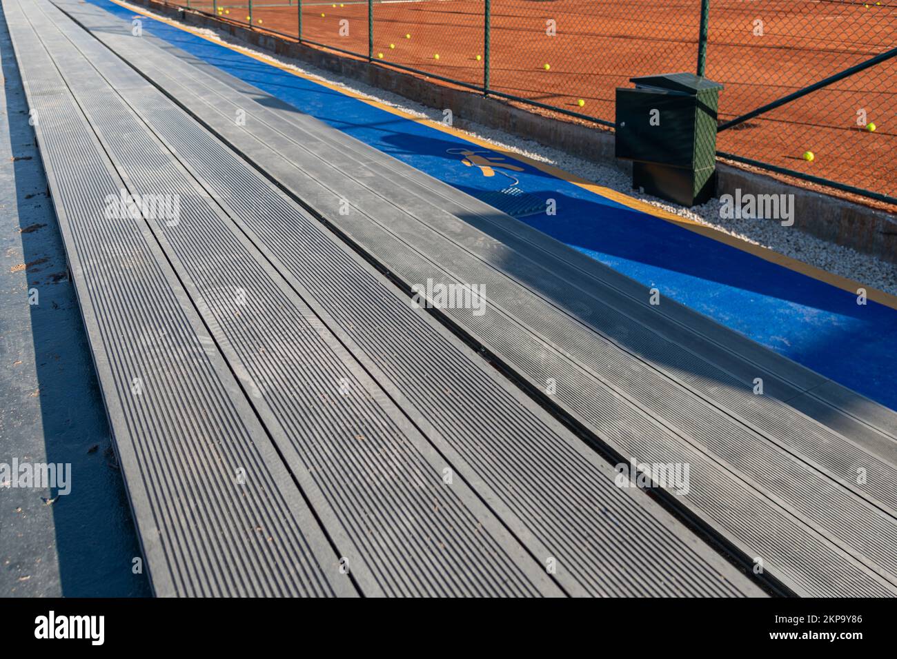 Seating area for spectators made with composite deck next to the tennis