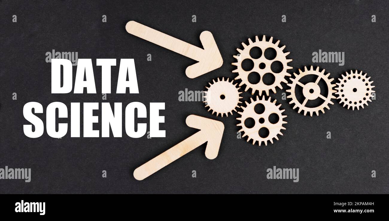 Industrial concept. On the black surface, arrows, gears and an inscription - DATA SCIENCE Stock Photo