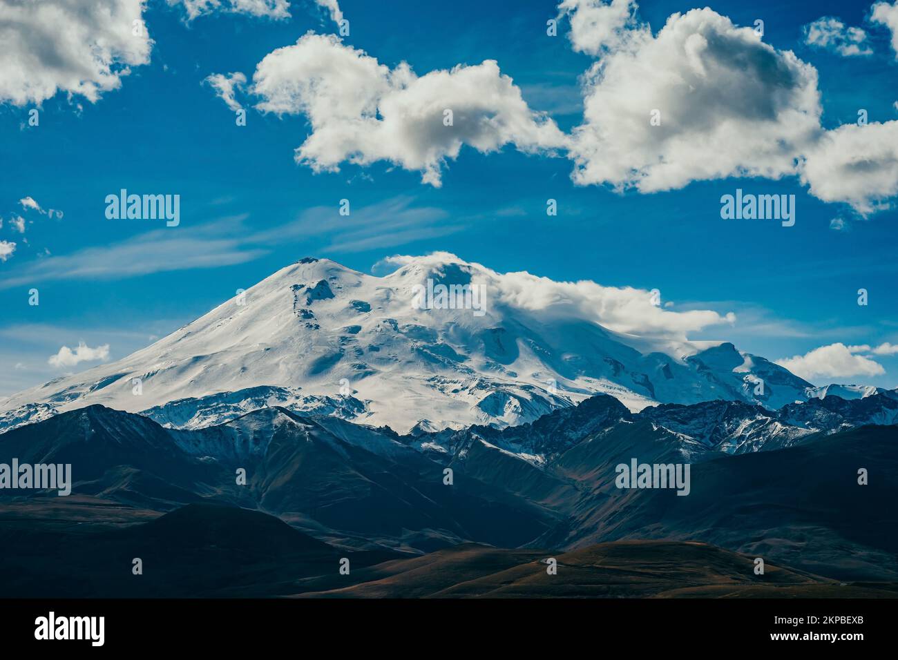 Big mountain Elbrus. Snow covered Greater Caucasus mountains. The two peaks of Mount Elbrus . Europe's highest peak. Journey to Kabardino-Balkaria. Russia. Stock Photo