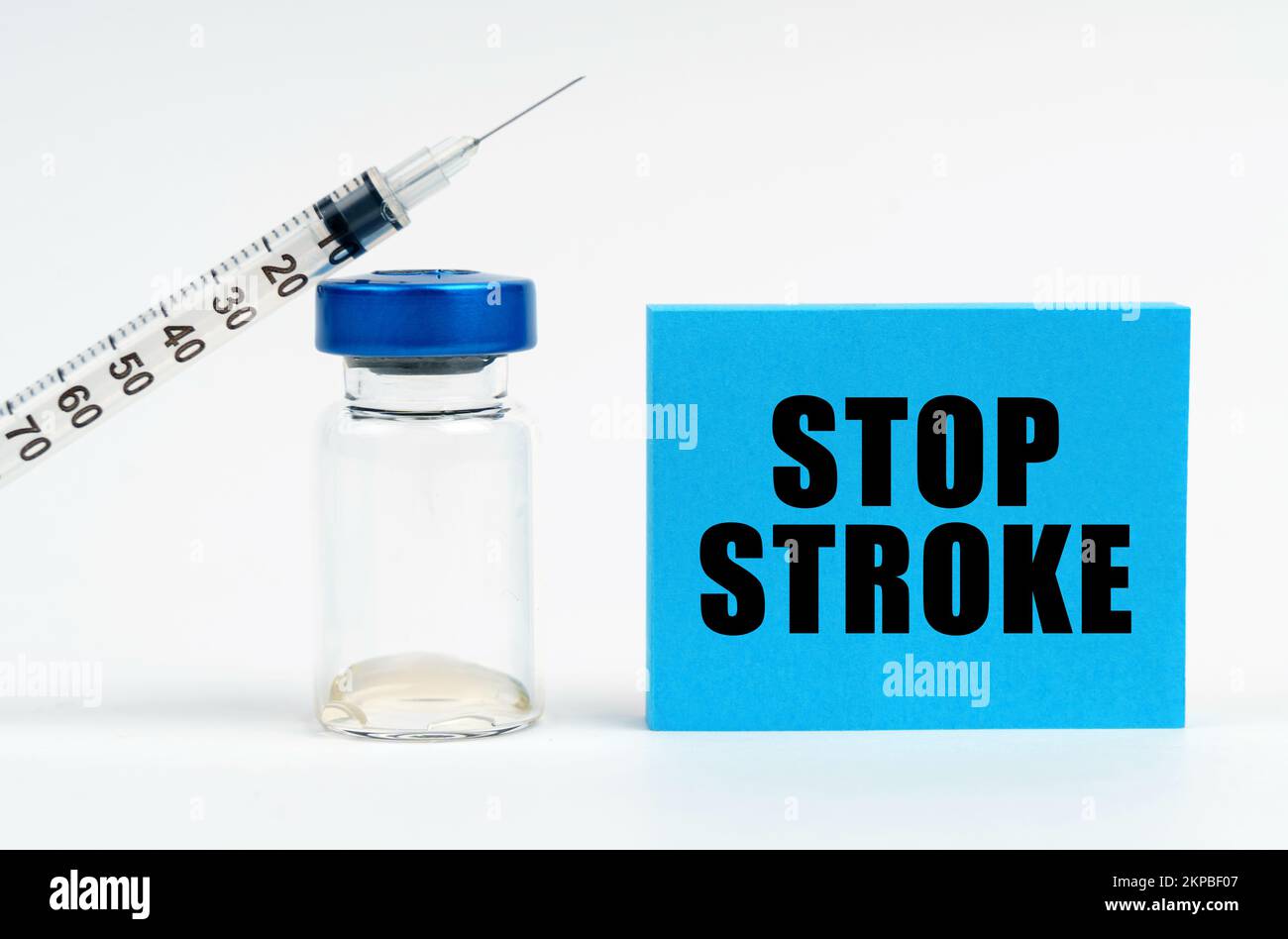 Medicine concept. On the table is a syringe, an injection and a blue sign with the inscription - STOP STROKE Stock Photo