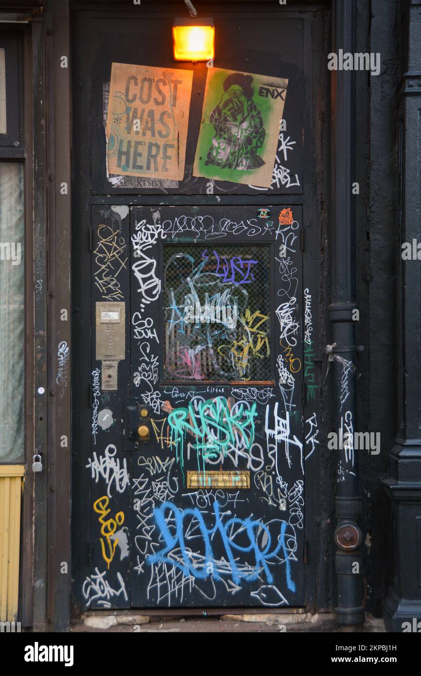 A collage of tagging, signs & graffiti on a doorway on the Lower East Side of Manhattan, New York City. Stock Photo