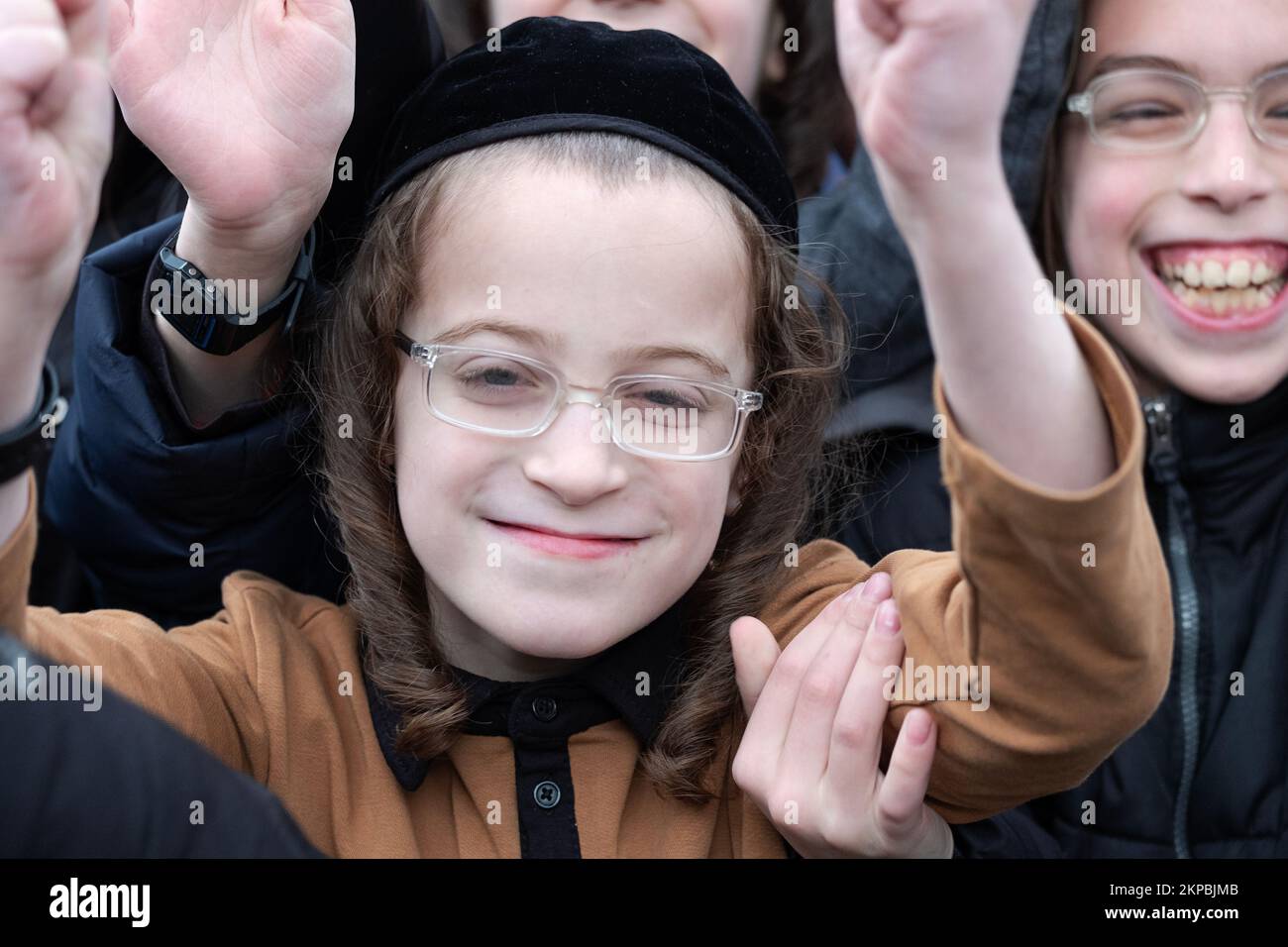 Smiling happy Hasidic Jewish children have fun with a photographer outside the Sobel Playground in Brooklyn, New York. Stock Photo