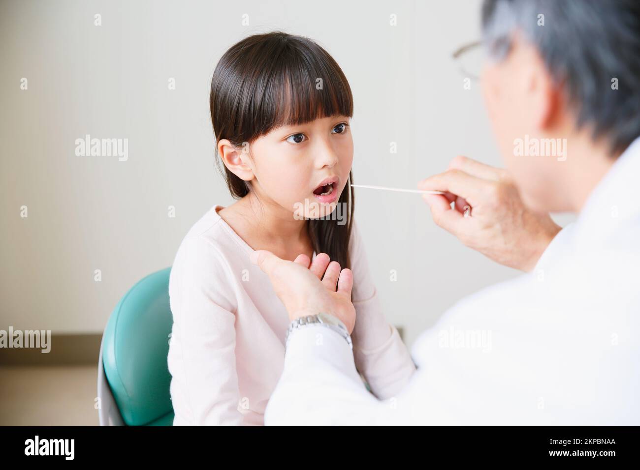 Japanese girl being examined by a doctor Stock Photo