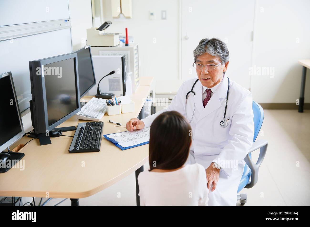 Girl being examined by a Japanese doctor Stock Photo
