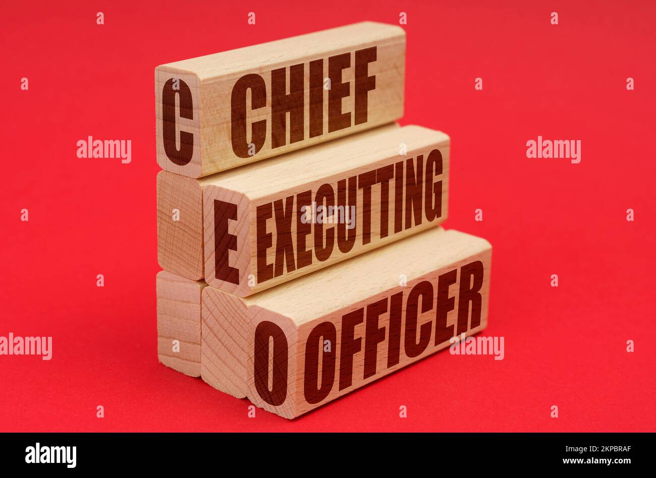 Business and economy concept. On a red background, wooden blocks with the inscription - Chief Executting Officer Stock Photo