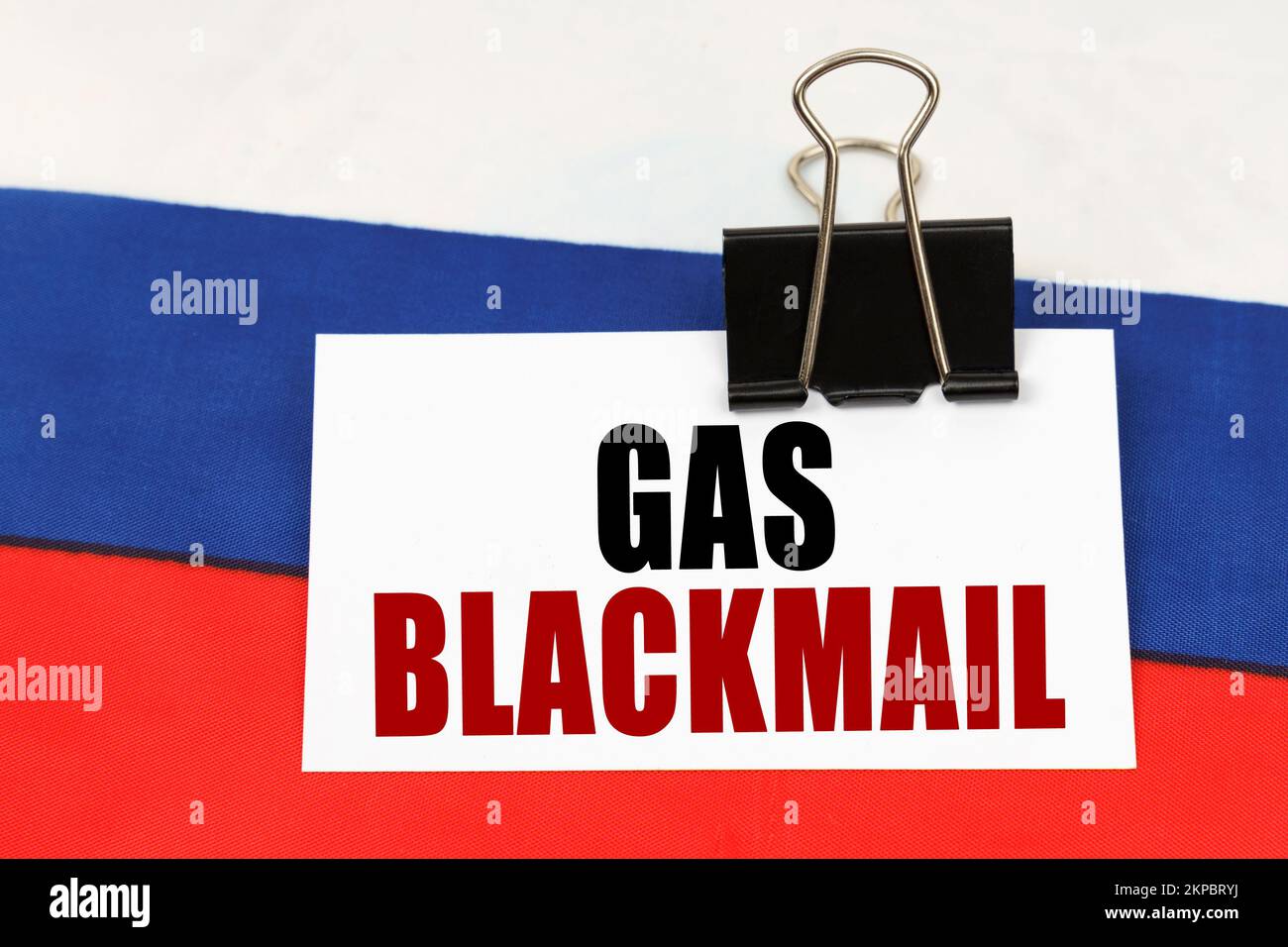 National concept. On the flag of Russia there is a business card with the inscription - Gas blackmail Stock Photo