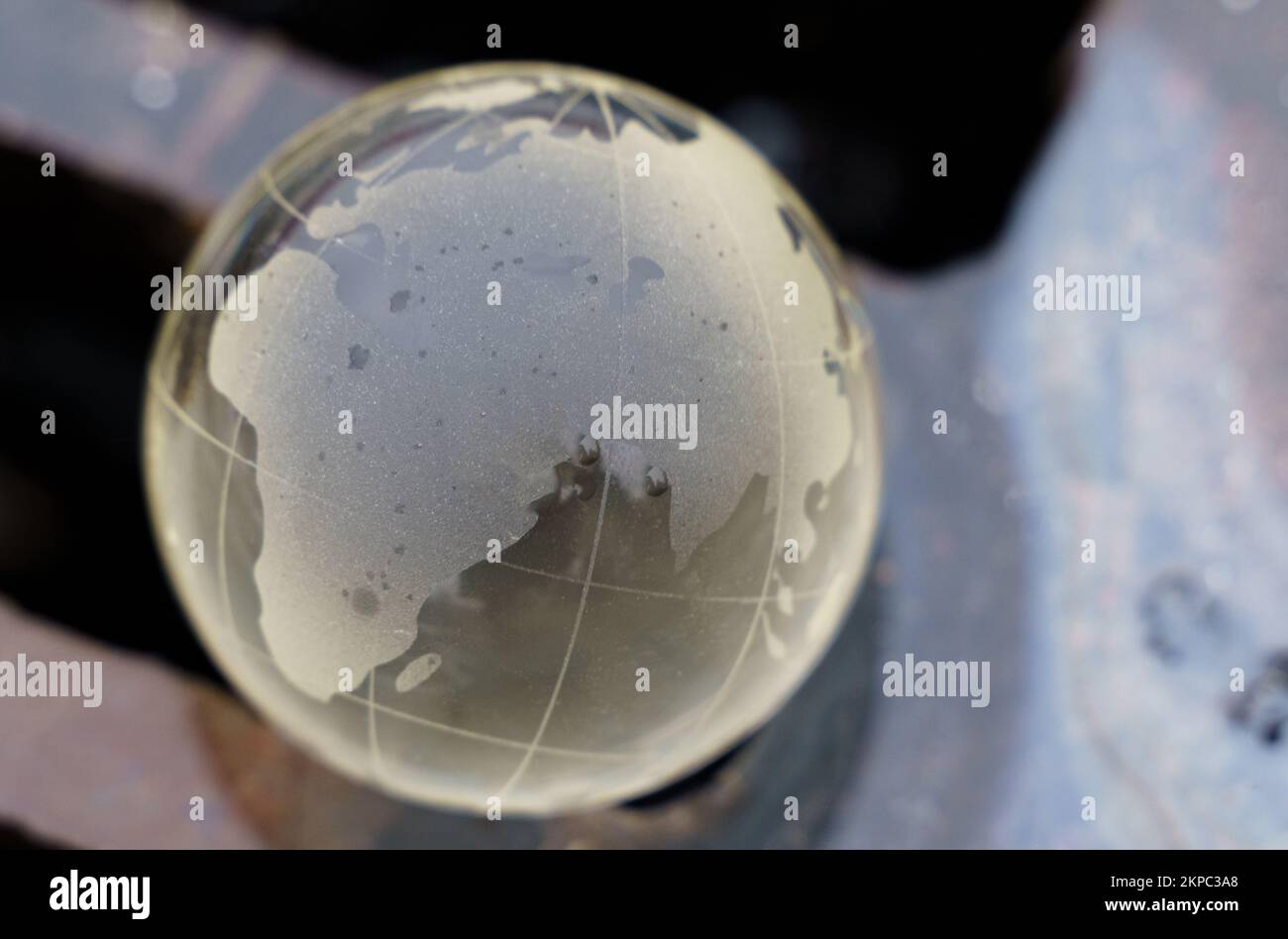 Environmental concept. Glass ball a lying on the grate of a