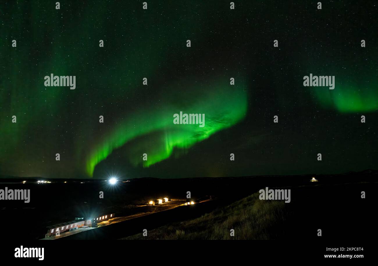 Aurora borealis green light beams over the houses Stock Photo