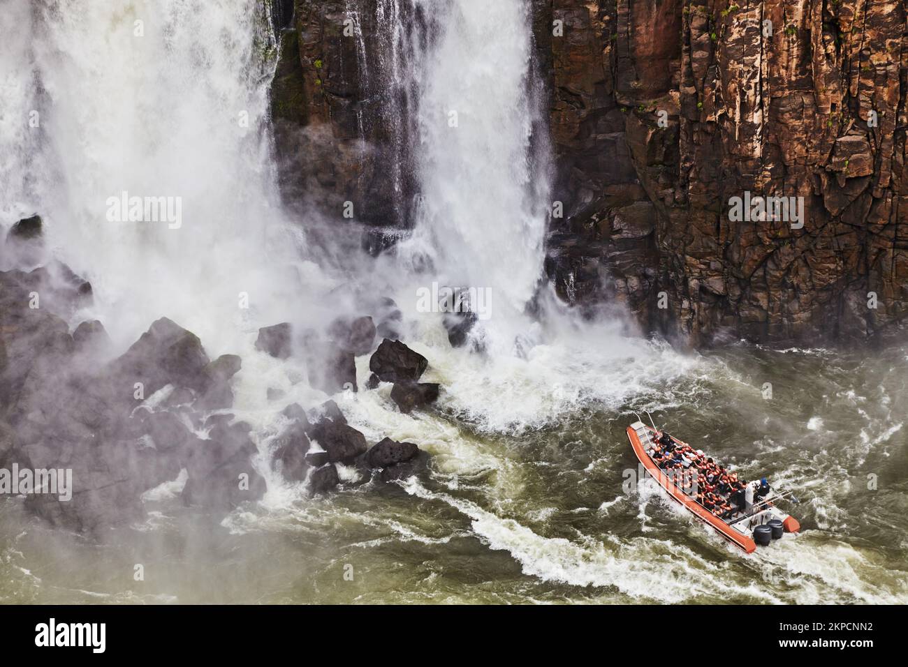 Popular tourist adventure activity at Iguazu Falls, speedboat approaches to water stream, view from Brazilian side Stock Photo
