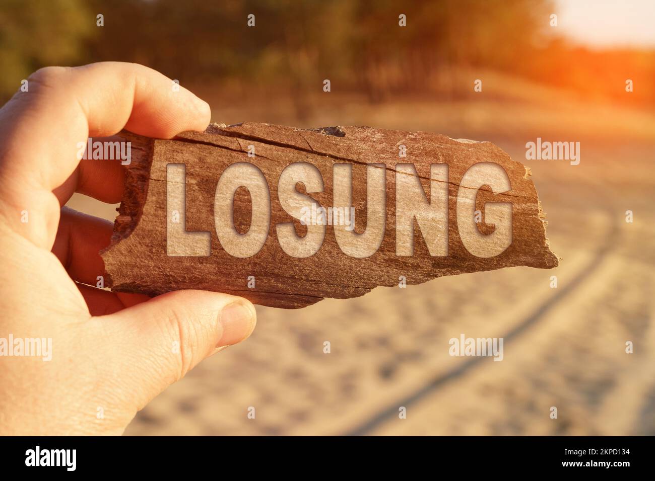 Business and miscellaneous concept. A man holds a sign in his hands - LOSUNG Stock Photo