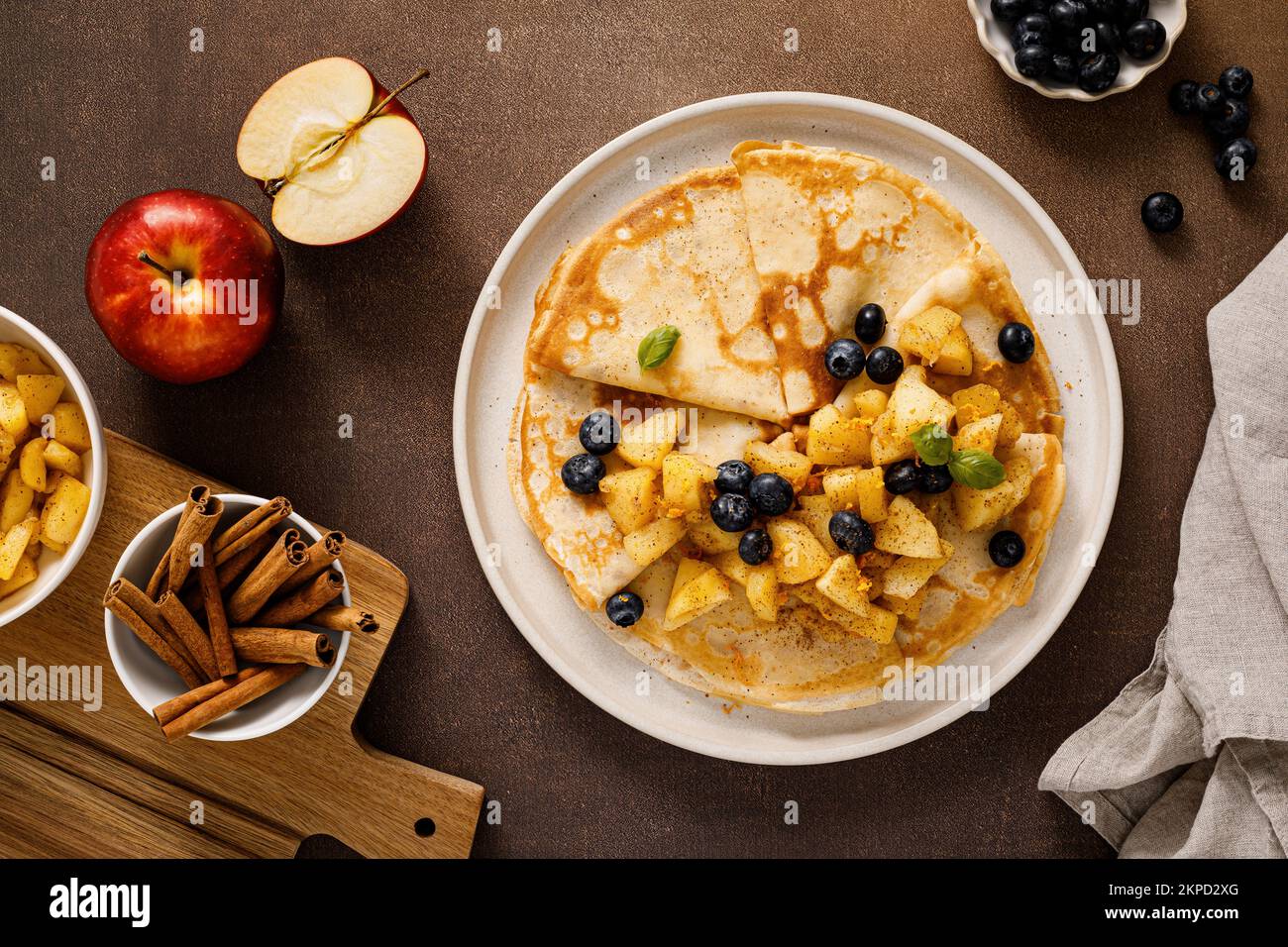 Crepes with caramelized cinnamon apples, top view Stock Photo