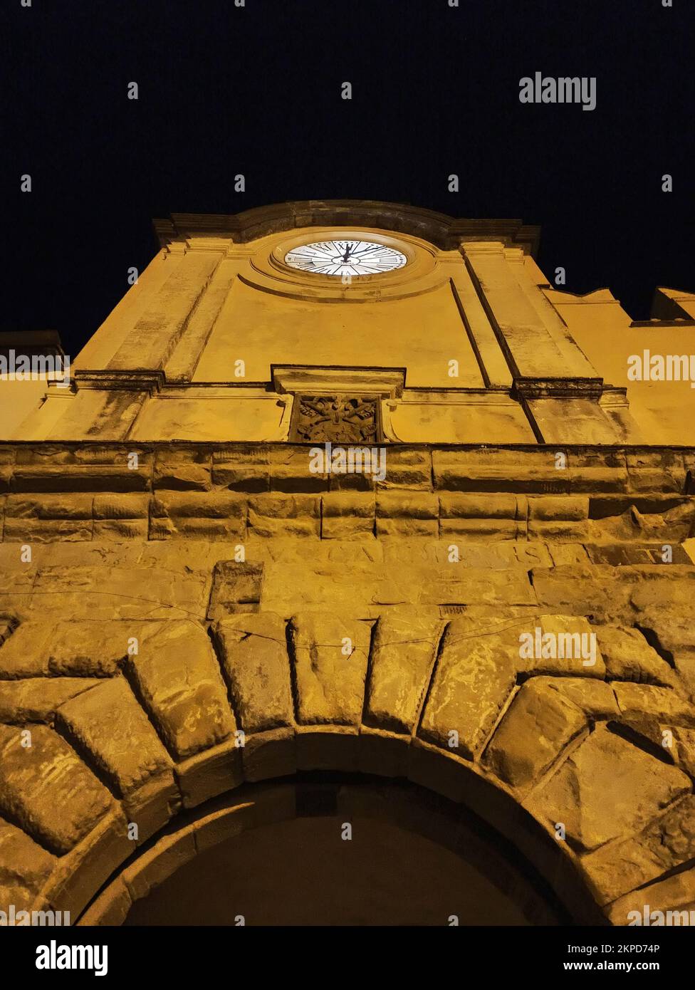 A vertical low angle shot of an old building with a clock during ...