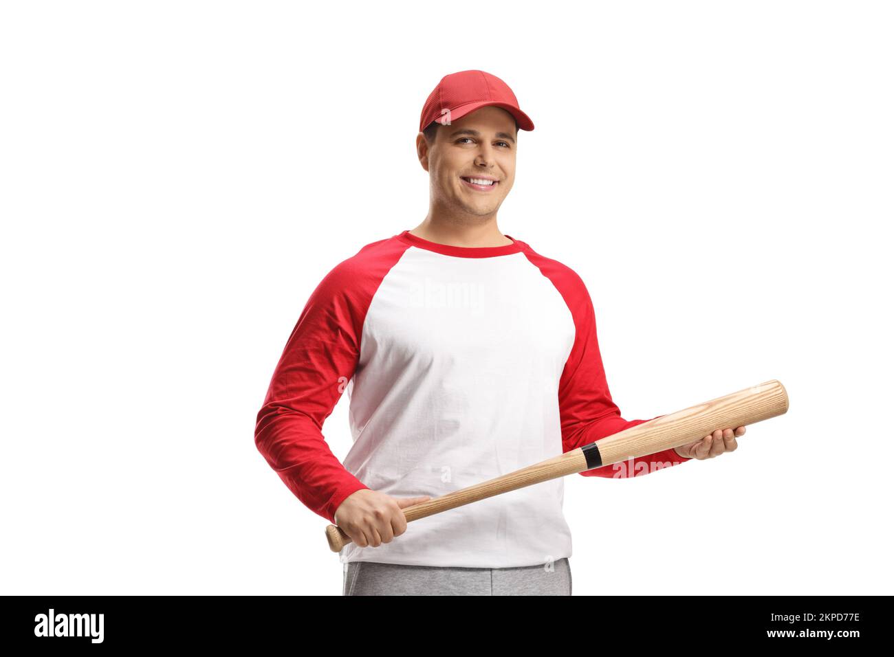 Young man with a baseball bat smiling at camera isolated on white background Stock Photo