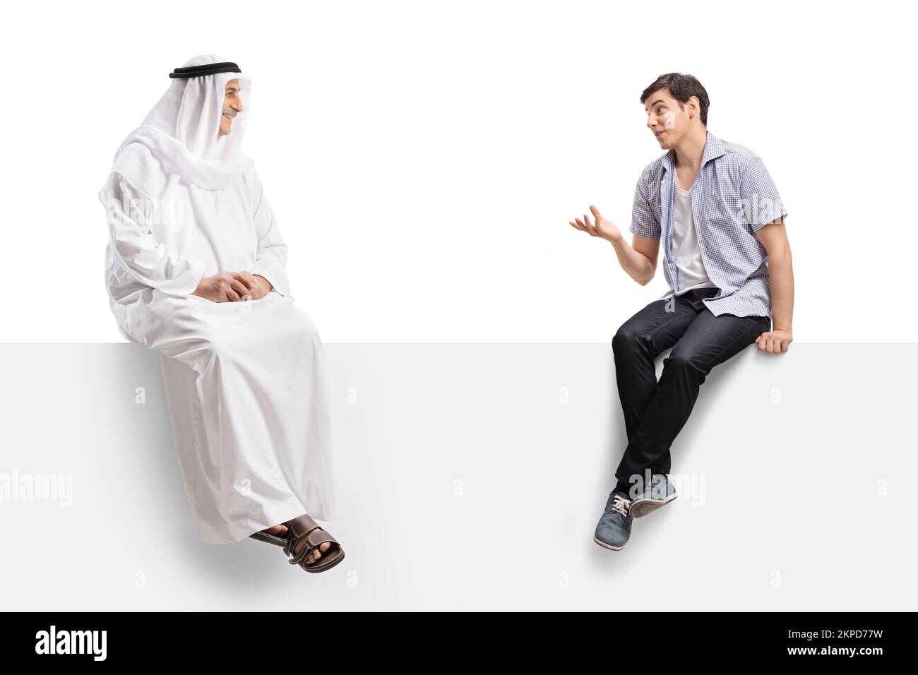 Casual guy sitting on a white panel and talking to a mature arab man isolated on white background Stock Photo