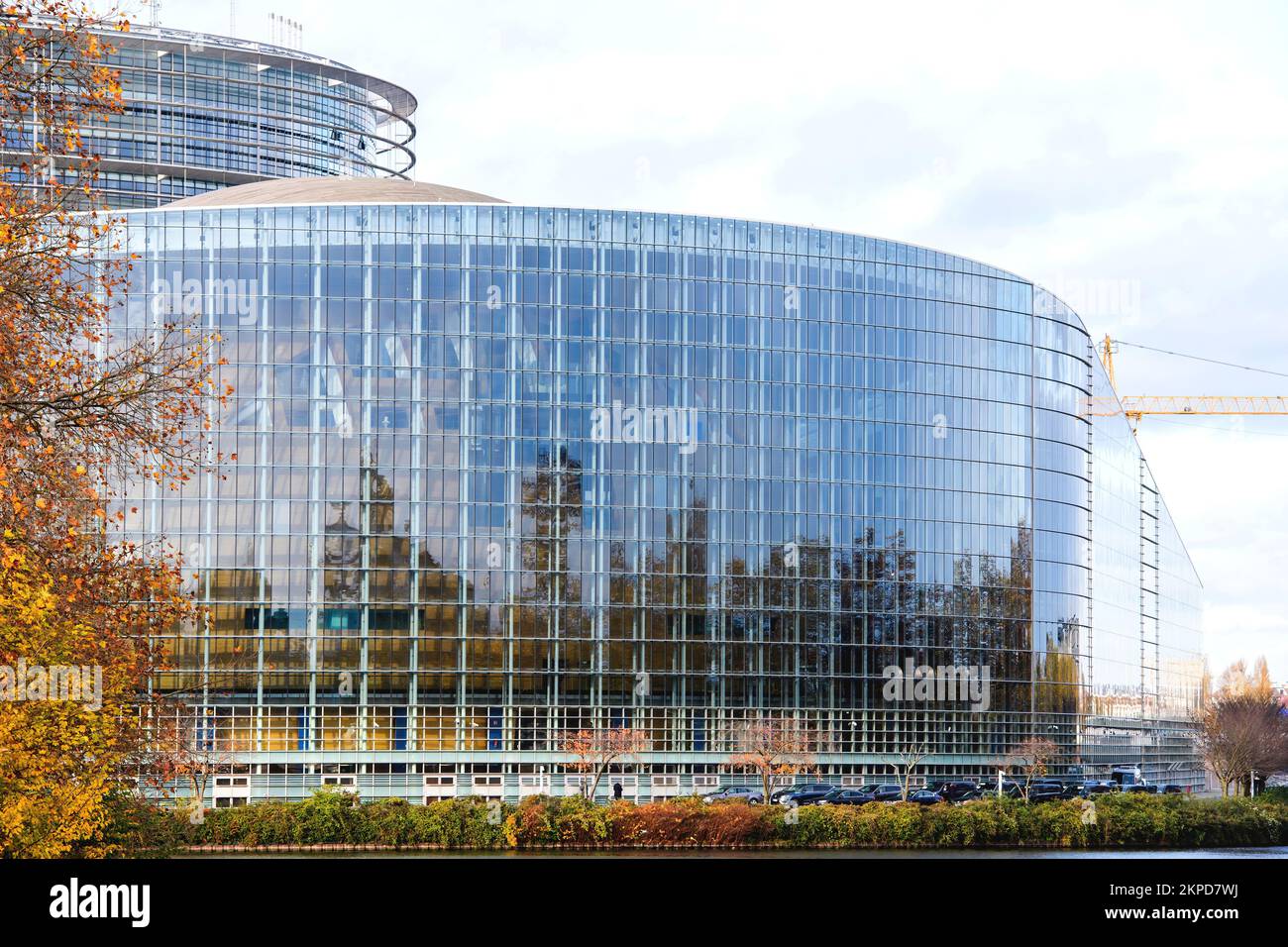 Strasbourg, France - Nov 22, 2022: Cars parked near European Parliament facade during 70 years of European democracy in action large banner on facade during ceremony marking the 70th anniversary Stock Photo