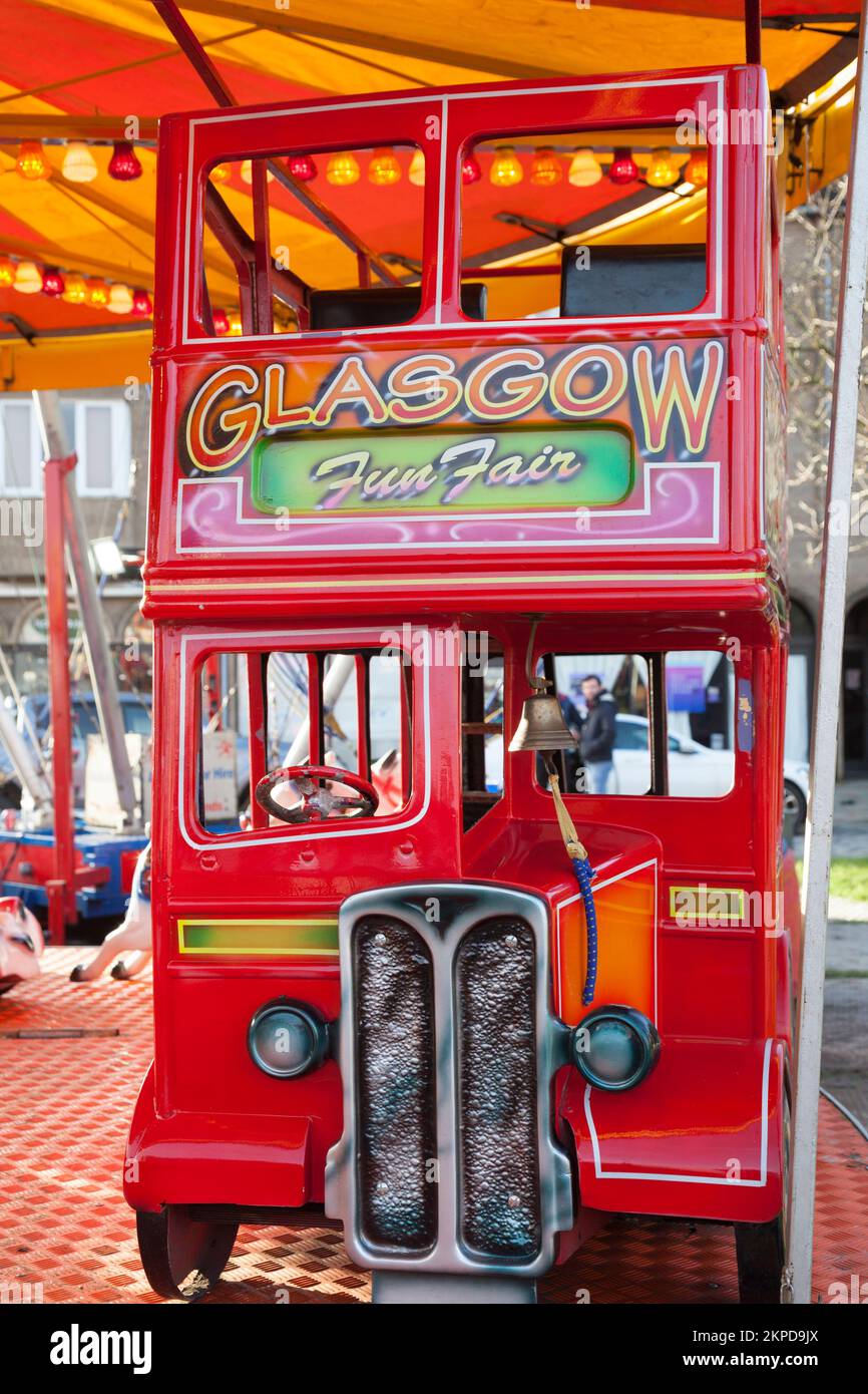 Red double decker bus on fairground ride, winter festival, Helensburgh, Scotland Stock Photo