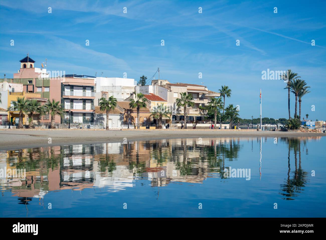 Building reflected in the calm waters of the Mar Menor on the Costa Calida in the Spanish resort of Los alcazares. Stock Photo