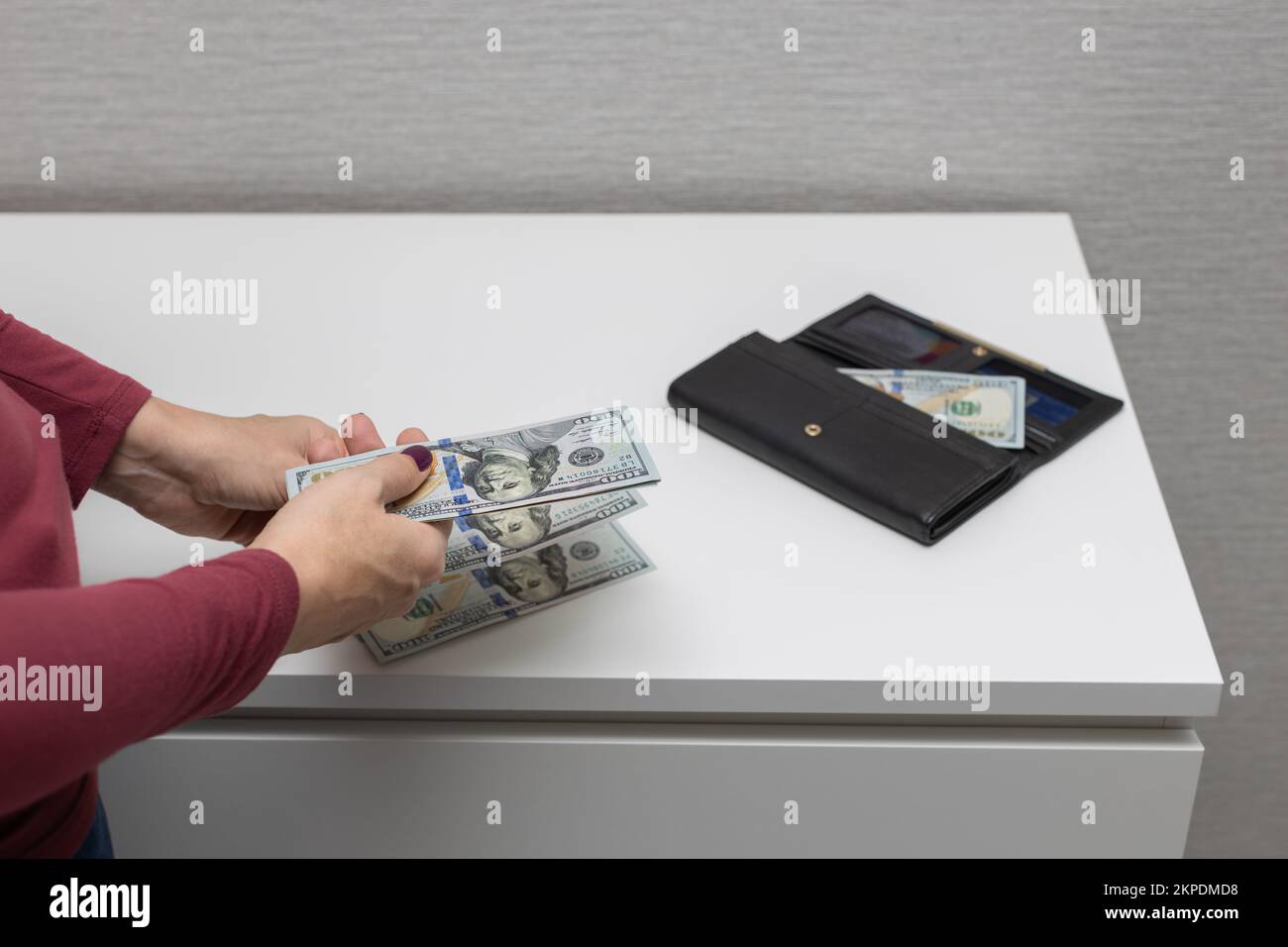 woman taking money out of wallet. man counting money. Wallet with money ...