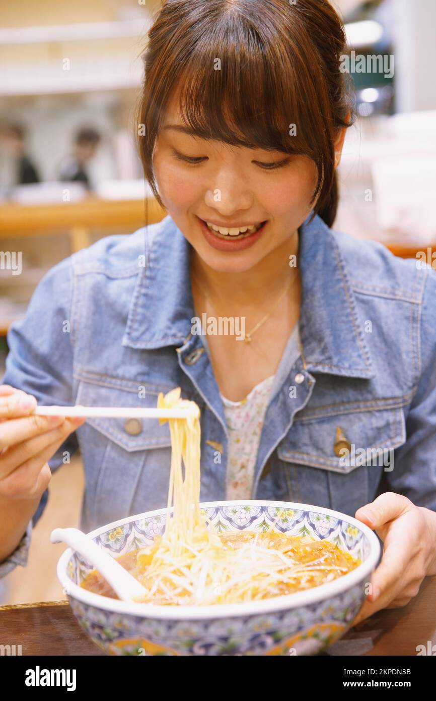 Japanese woman eating tantan noodles Stock Photo Alamy