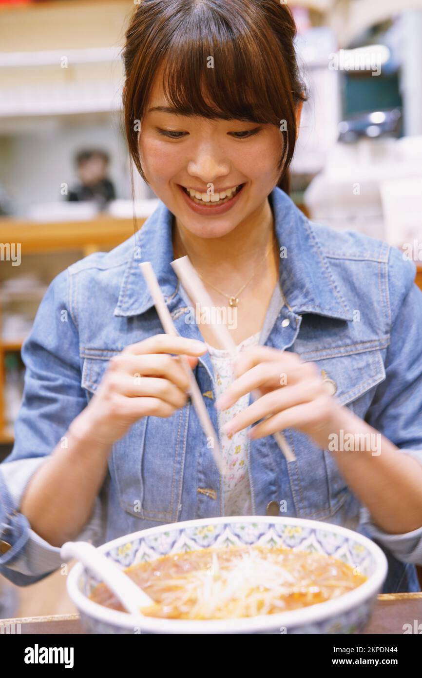 Japanese woman eating tantan noodles Stock Photo Alamy