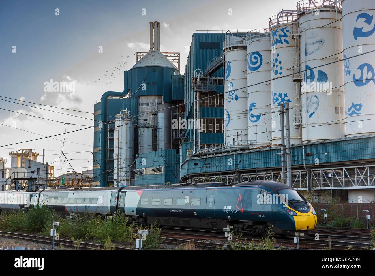 Avanti Pendolino train passing the Unilever factory at Warrington. Stock Photo