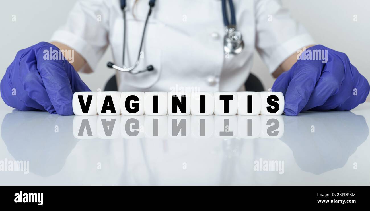 Medicine and health concept. The doctor put together a word from cubes VAGINITIS Stock Photo