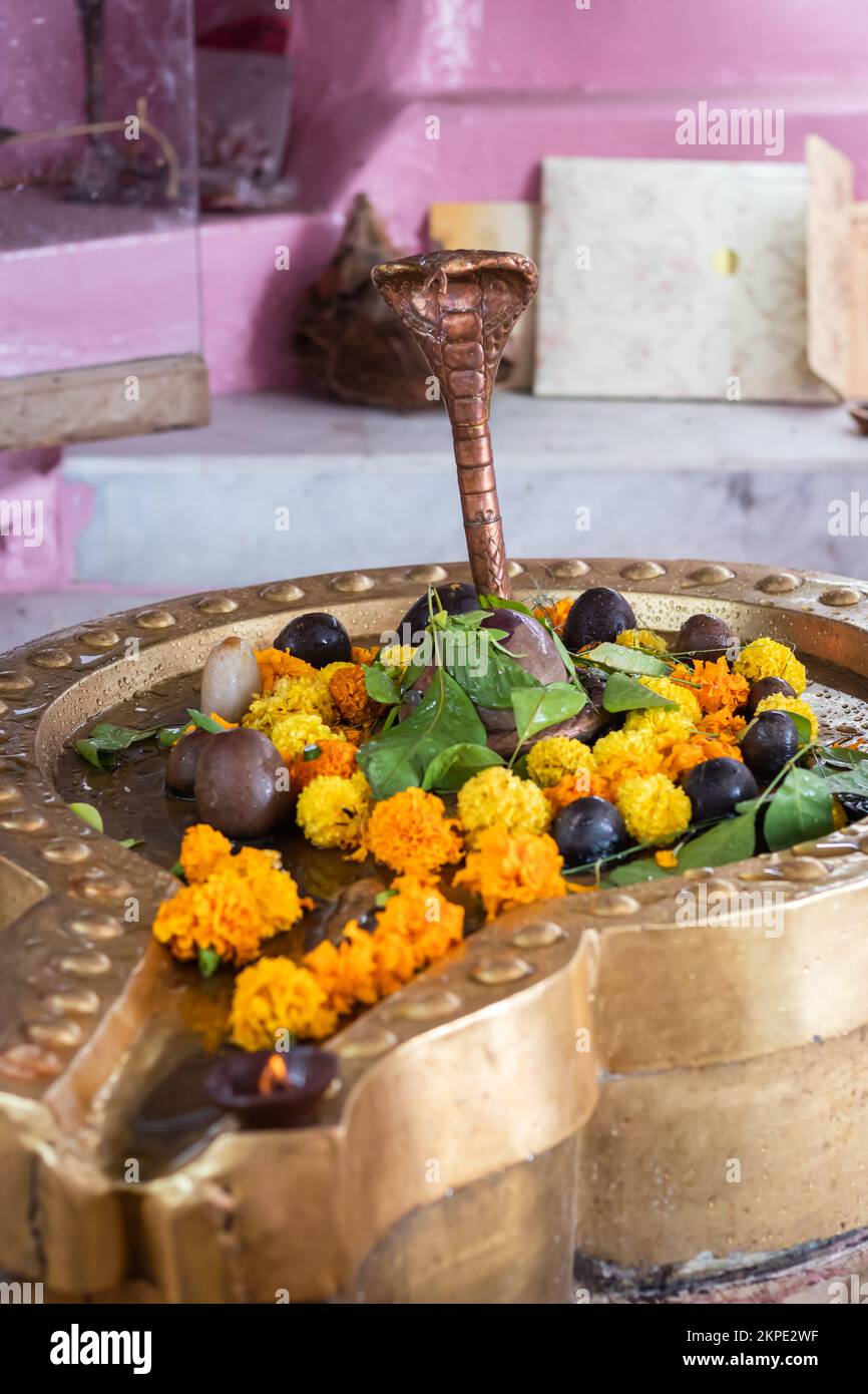 hindu god shivalinga worshiped with flower and bell paper at temple Stock Photo