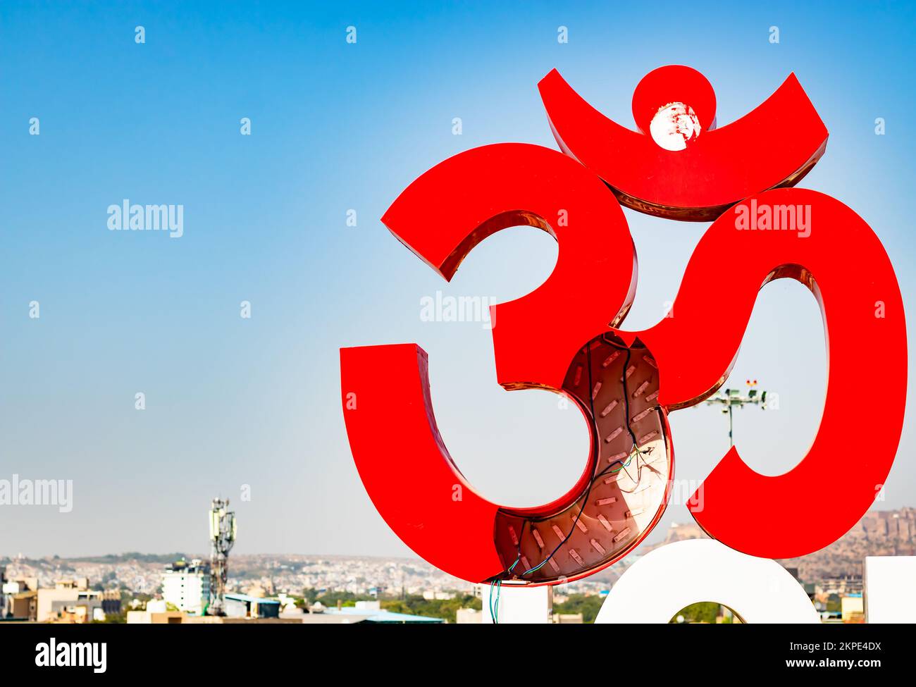 holy om sign board with bright blue sky at morning from flat angle image is taken at ratanada jodhpur rajasthan india on Nov 14 2022. Stock Photo