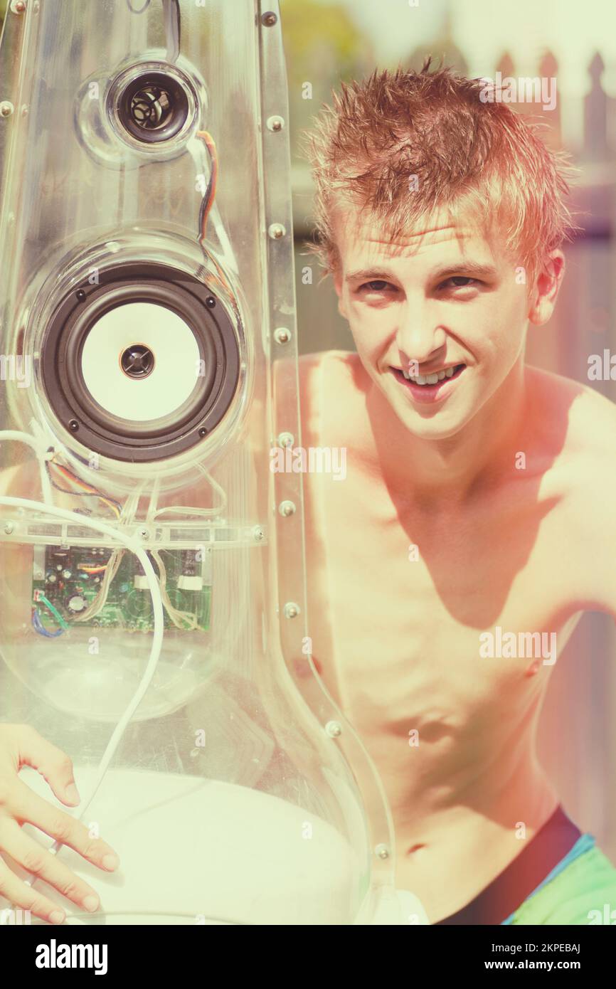 Music man listening to radio through beer bottle stereo during bright