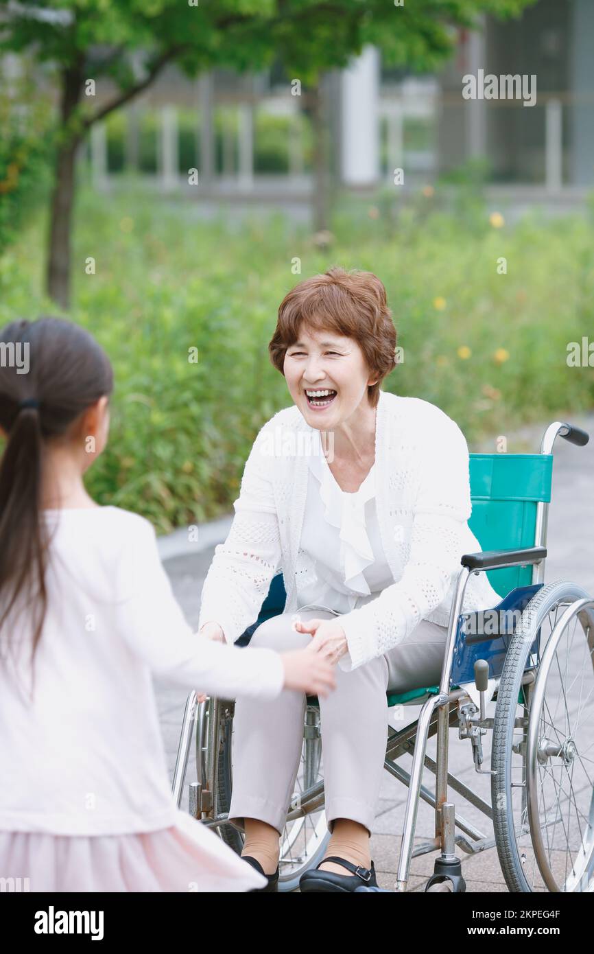 Japanese senior woman in a wheelchair and grandchild Stock Photo Alamy