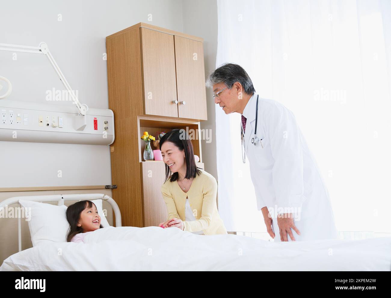 Japanese girl being examined by a doctor in a hospital room Stock Photo