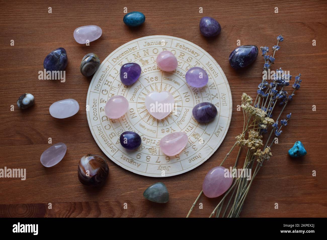 Gemstones for zodiac signs, amethysts and rose quartz on the zodiac chart. Predictions, witchcraft, spiritual esoteric practice. Stock Photo