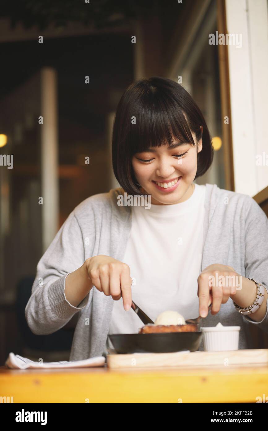 Young Japanese woman eating french toast Stock Photo Alamy