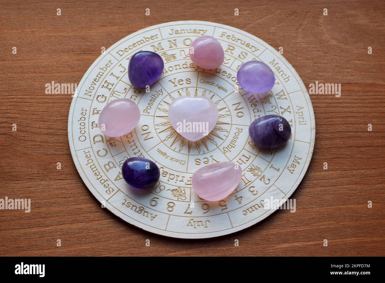 Gemstones for zodiac signs, amethysts and rose quartz on the zodiac chart. Predictions, witchcraft, spiritual esoteric practice. Stock Photo