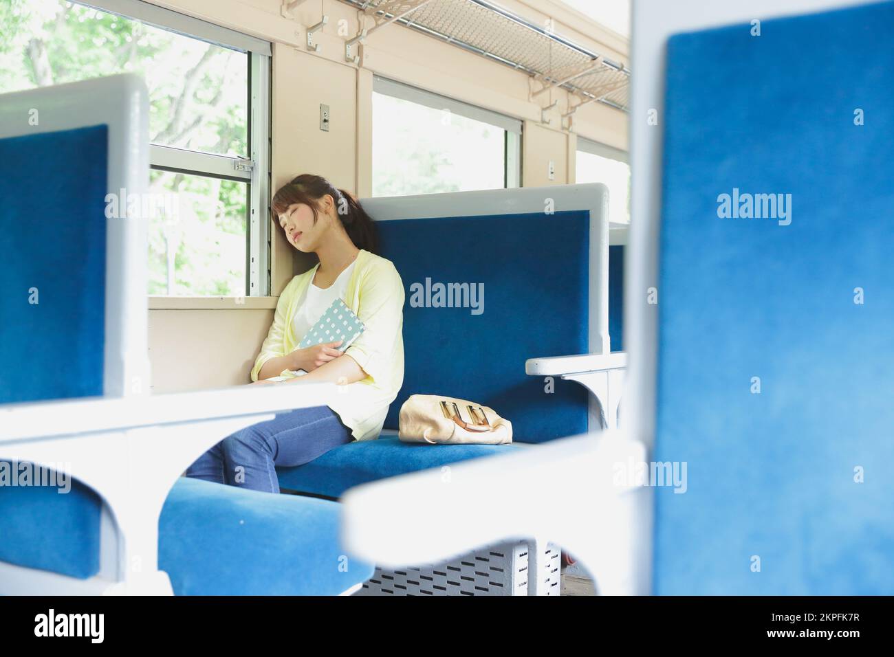 Woman on train bag on seat hi-res stock photography and images - Alamy