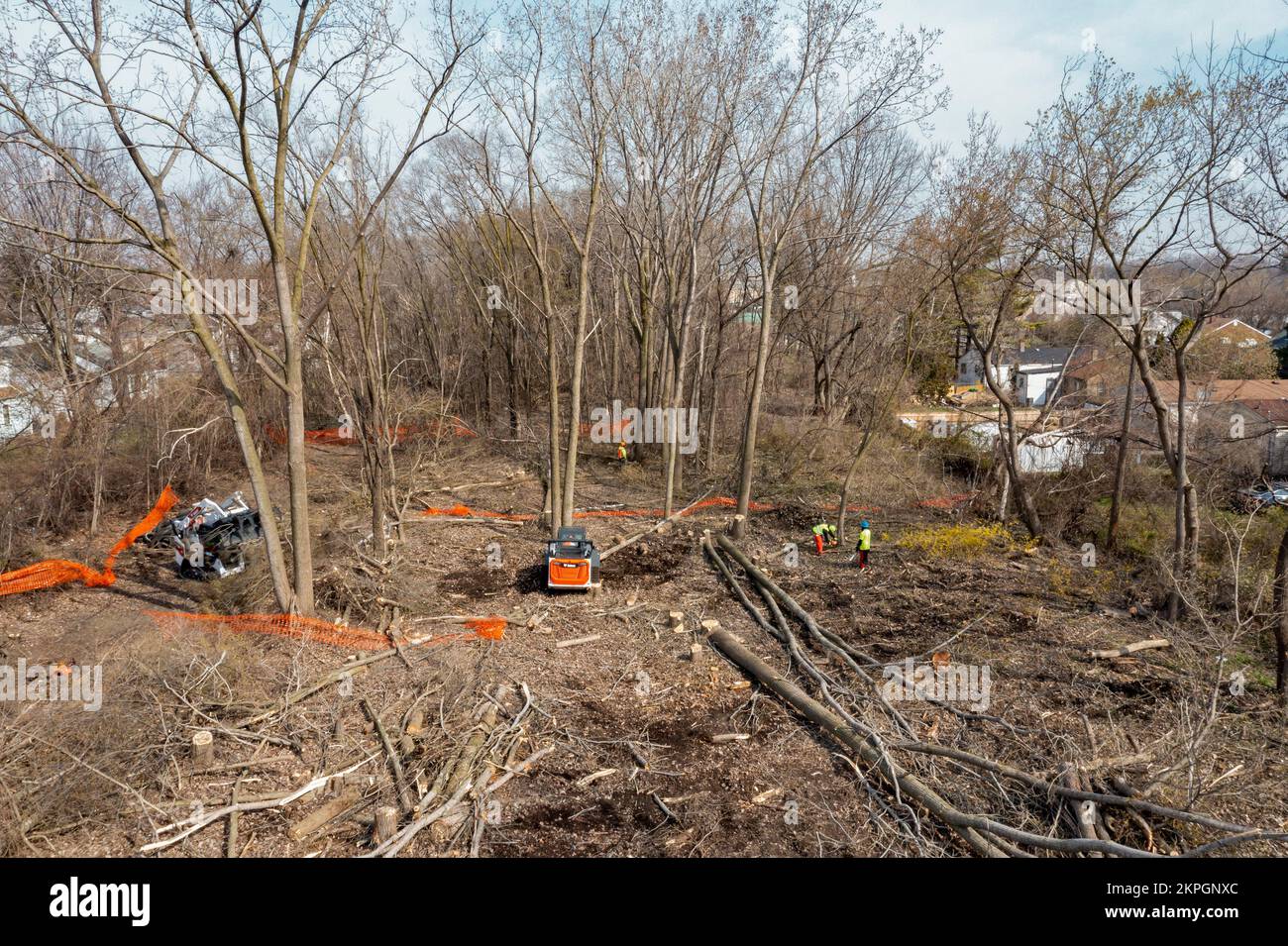 Detroit, Michigan - Workers clear trees from an abandoned railroad right of way that will be part of the Joe Lewis Greenway, a 27.5 mile hiking and bi Stock Photo