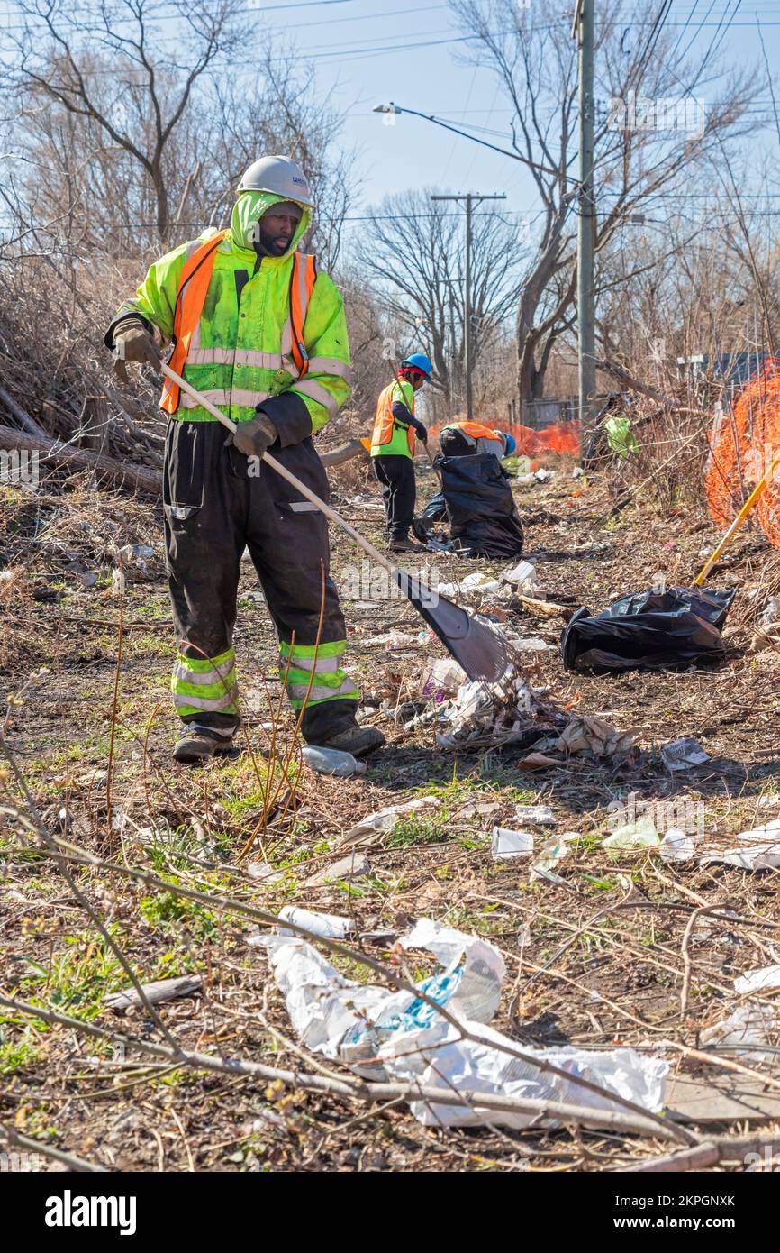Detroit, Michigan - Workers clear brush and debris from an abandoned railroad right of way that will be part of the Joe Lewis Greenway, a 27.5 mile hi Stock Photo