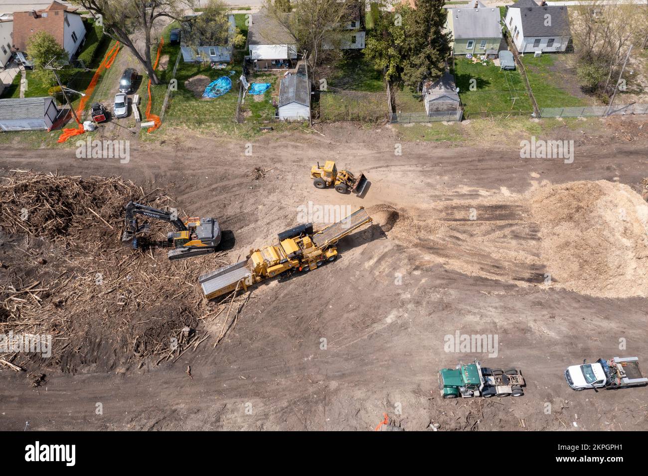 Detroit, Michigan - Using heavy equipment, workers clear trees, shredding them into woodchips, from an abandoned railroad right of way. They are clear Stock Photo