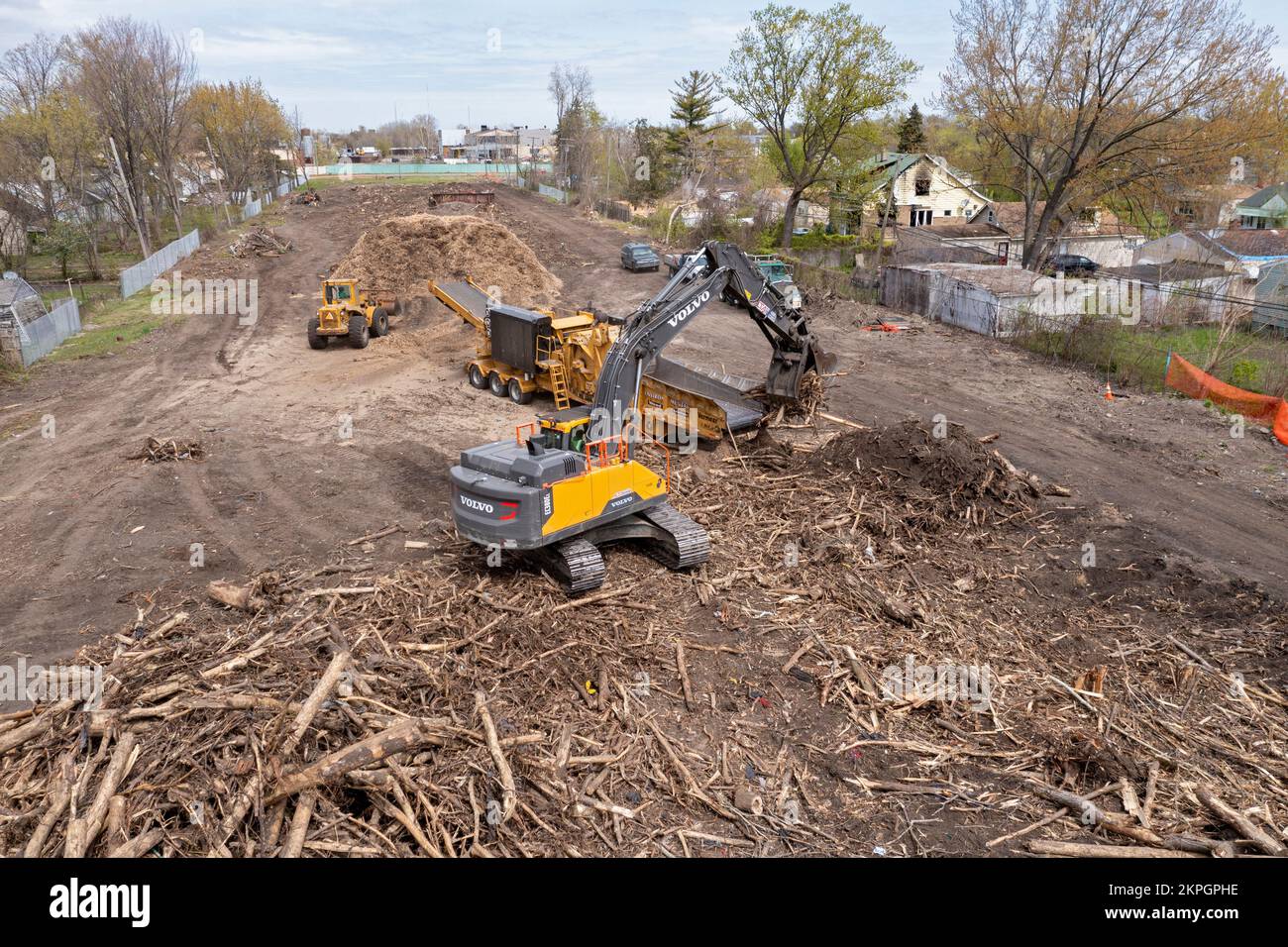 Detroit, Michigan - Using heavy equipment, workers clear trees, shredding them into woodchips, from an abandoned railroad right of way. They are clear Stock Photo