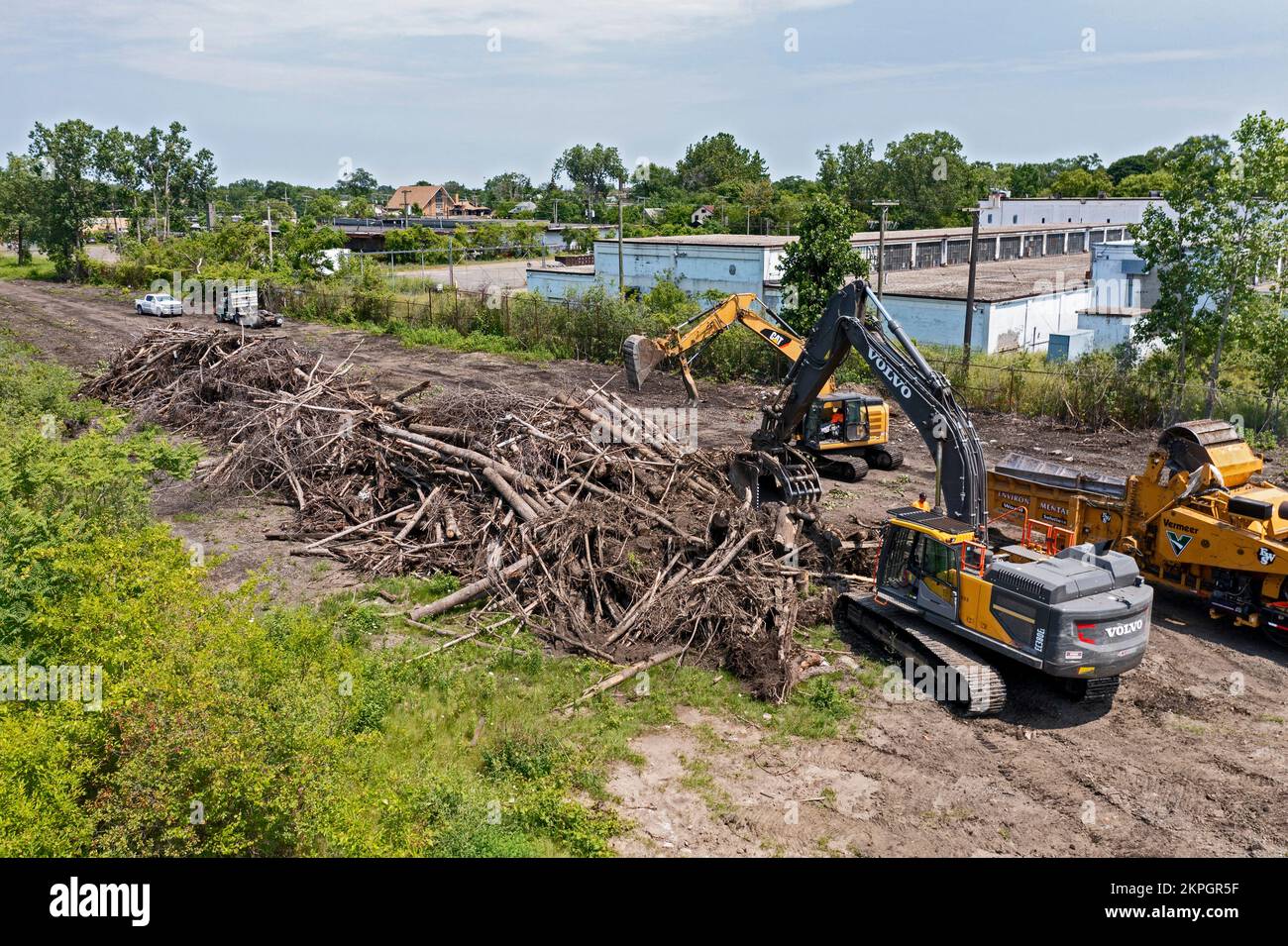 Detroit, Michigan - Using heavy equipment, workers clear trees, shredding them into woodchips, from an abandoned railroad right of way. They are clear Stock Photo