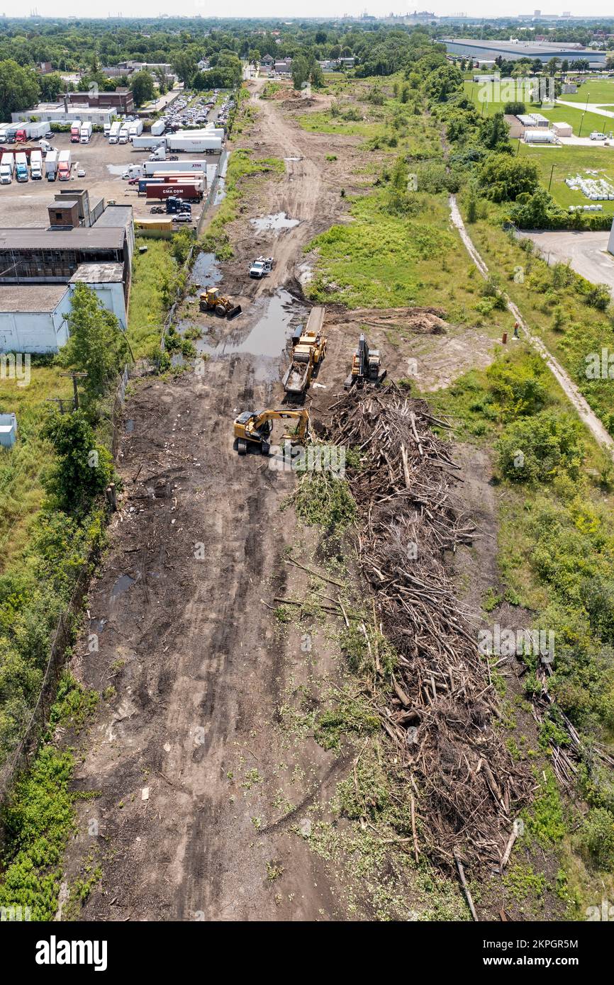 Detroit, Michigan - Using heavy equipment, workers clear trees, shredding them into woodchips, from an abandoned railroad right of way. They are clear Stock Photo