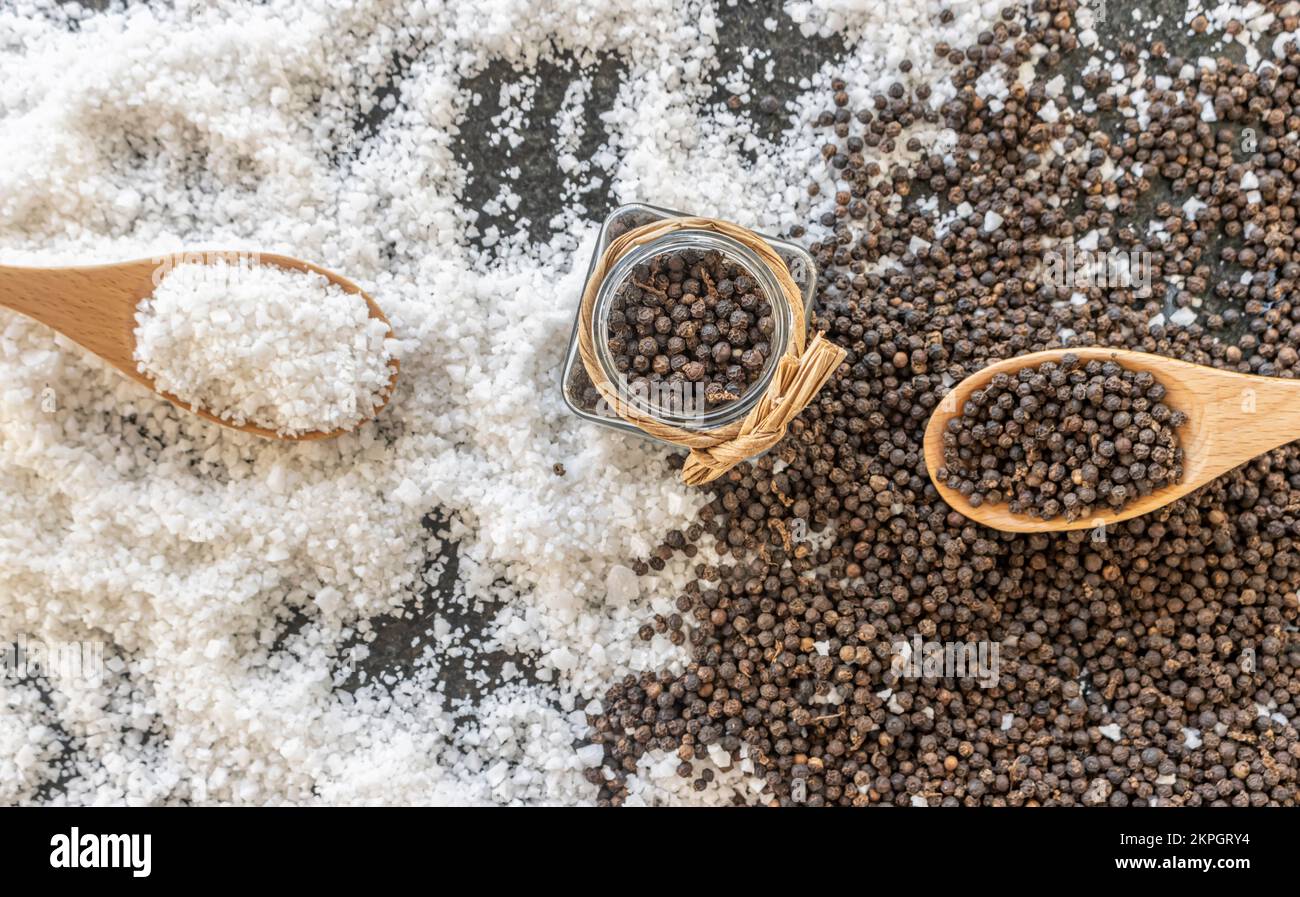 Spoon and glass jar filled with Kampot pepper (French name poivre d