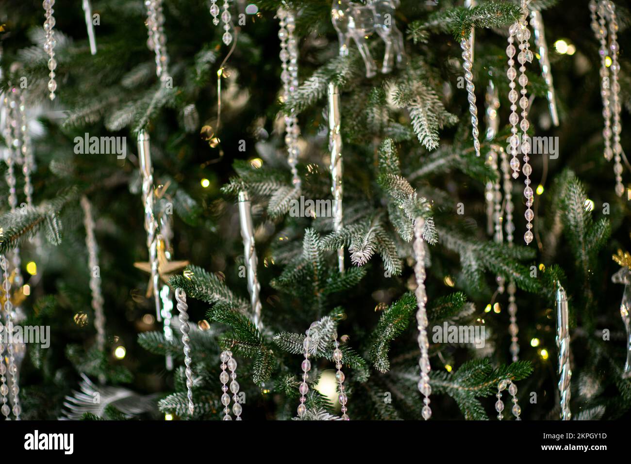 Close-up of a festively decorated outdoor Christmas tree with balls on ...