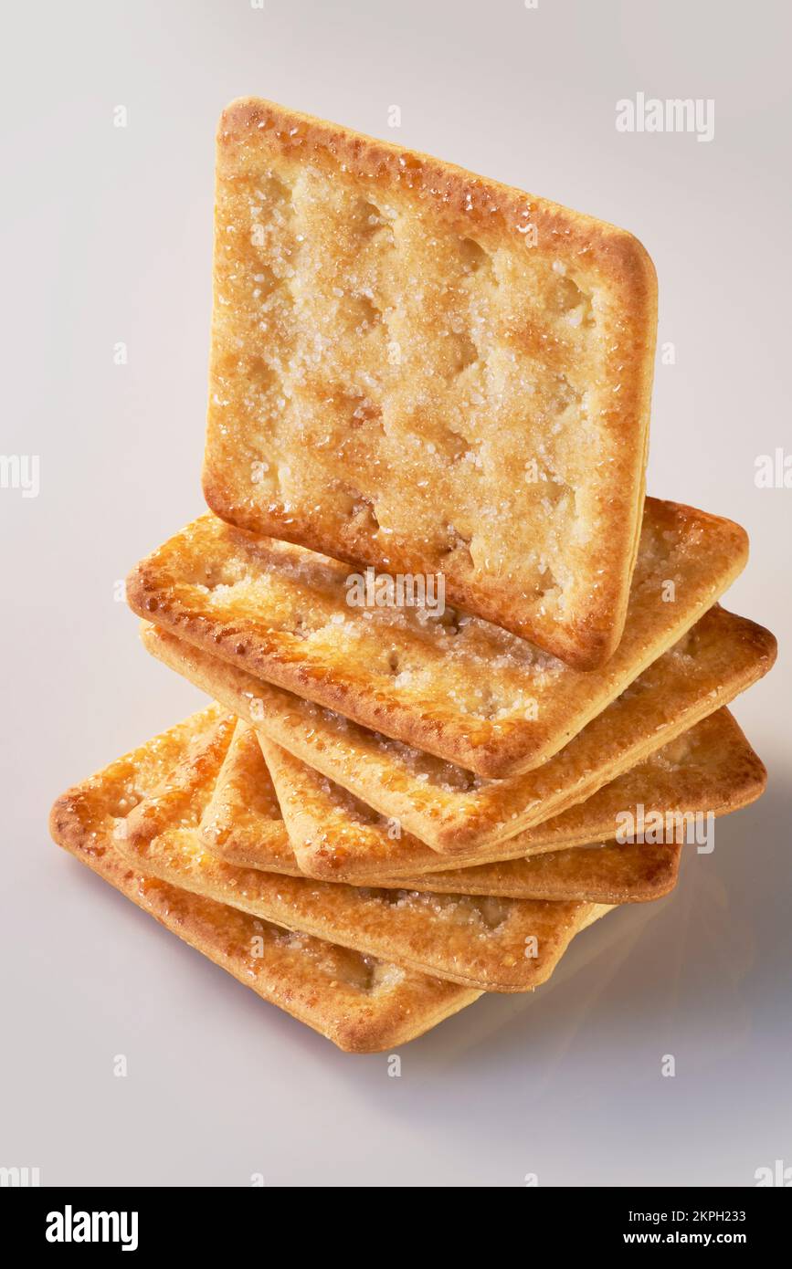 A pile of seven sugarcoated sweet crackers with one standing on top